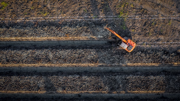 High angle view backhoe is dingging the groove garden and agricultural area Thailand 