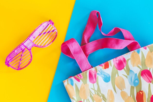 High angle view of bag with plastic sunglasses on table