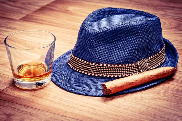 High angle view of beer in glass and hat on table