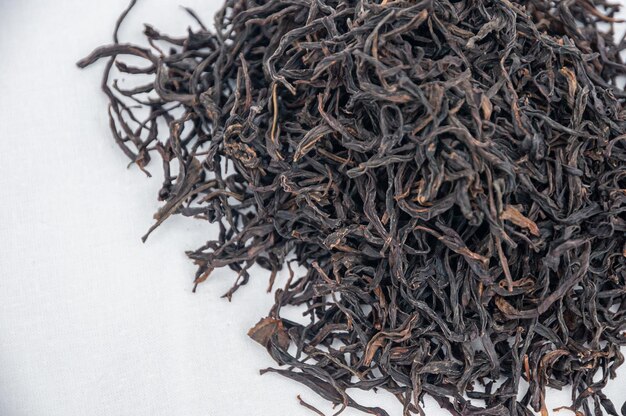 High angle view of black tea on white background