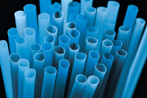 High angle view of blue plastic drinking straws