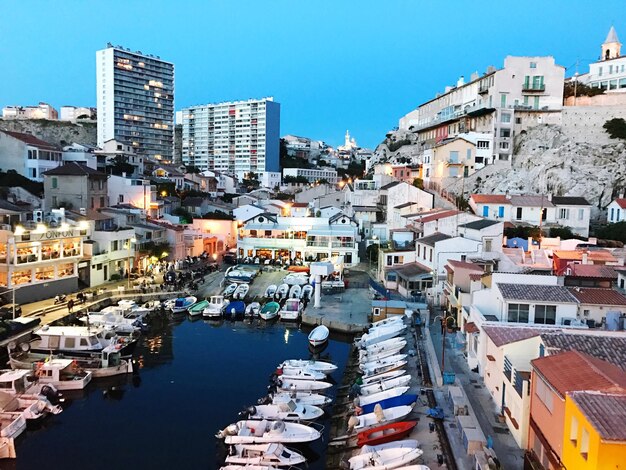 High angle view of boats moored in city against clear sky