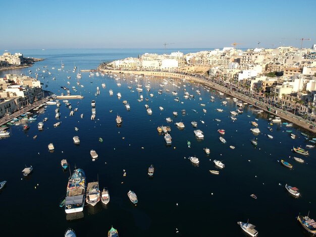 High angle view of boats on sea in city