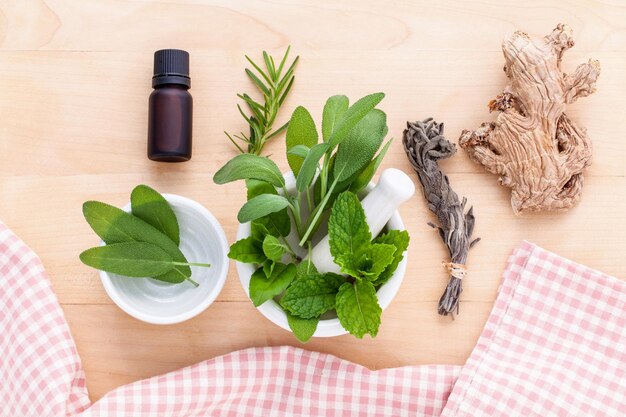 High angle view of bottle with leaves on wooden table