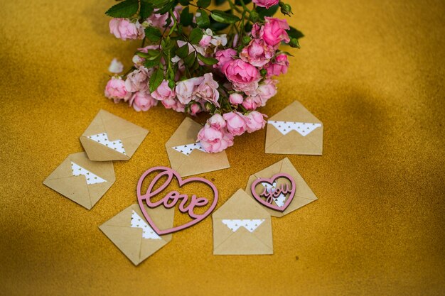 High angle view of bouquet with envelopes on table