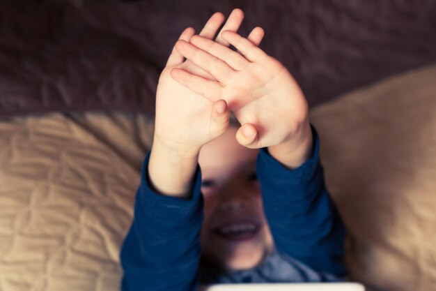 家でベッドに横たわっている男の子のハイアングルビュー