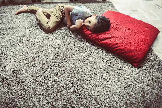 High angle view of boy relaxing on rug at home