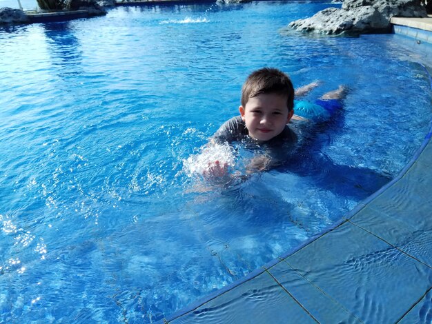 High angle view of boy swimming in pool