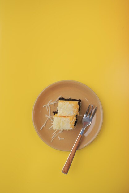 High angle view of breakfast in plate against yellow background