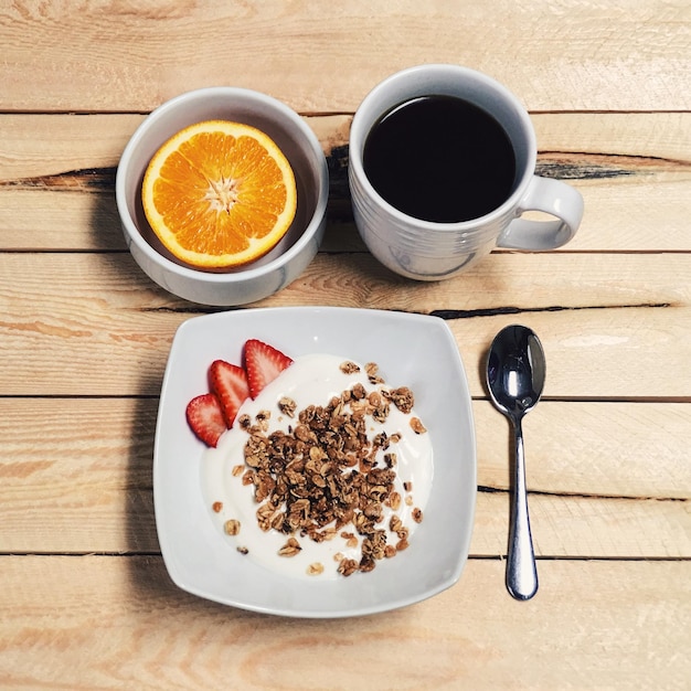 High angle view of breakfast on wooden table