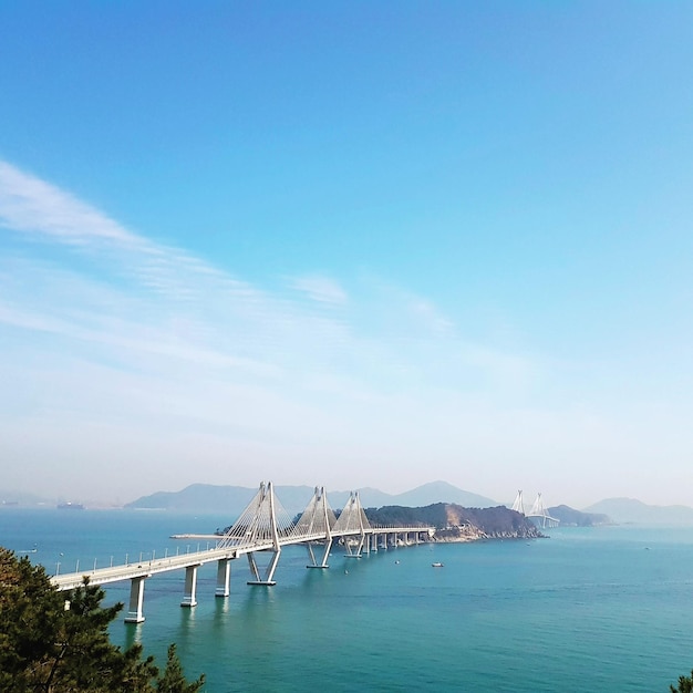 High angle view of bridge over sea against blue sky