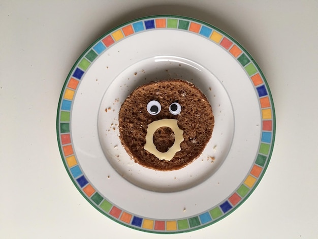 High angle view of brown bread in plate on white background