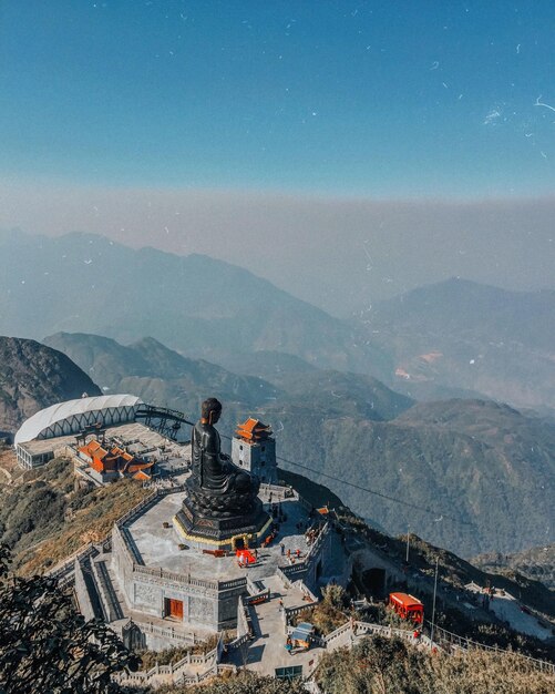 High angle view of buddha statue on mountain against sky