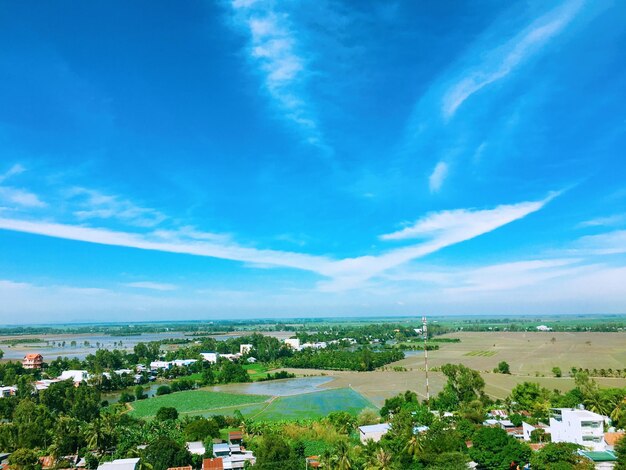 High angle view of buildings against blue sky