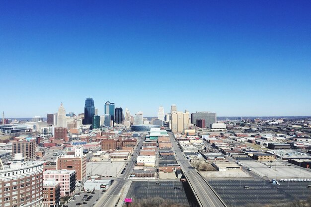 High angle view of buildings against clear blue sky