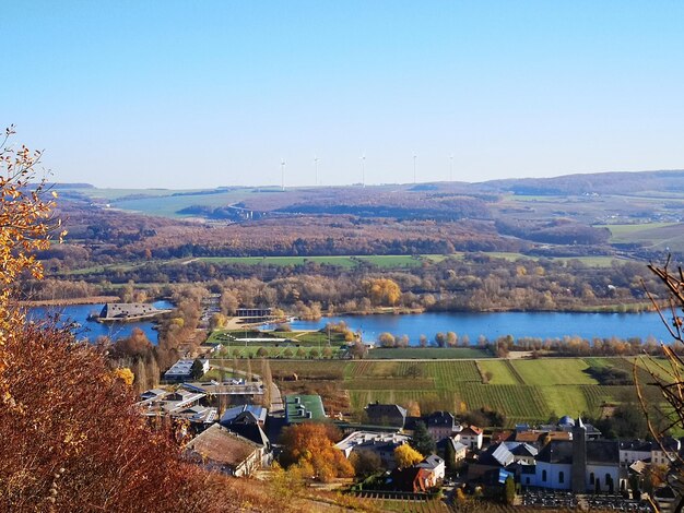 High angle view of buildings by lake against sky