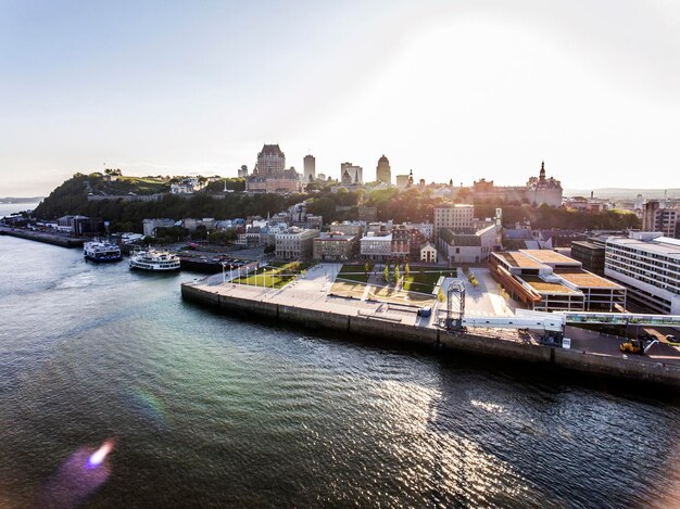 High angle view of buildings by river against sky