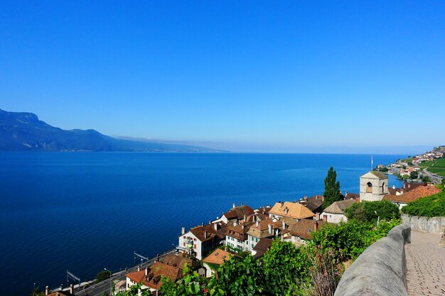 High angle view of buildings by sea against clear sky