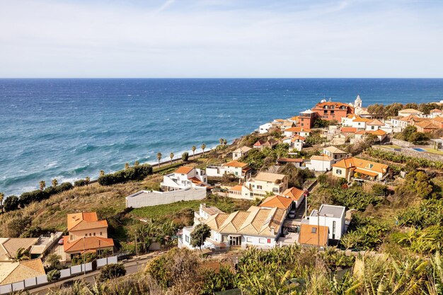 High angle view of buildings by sea against sky