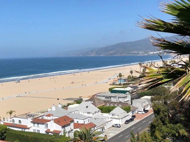 High angle view of buildings by sea against sky