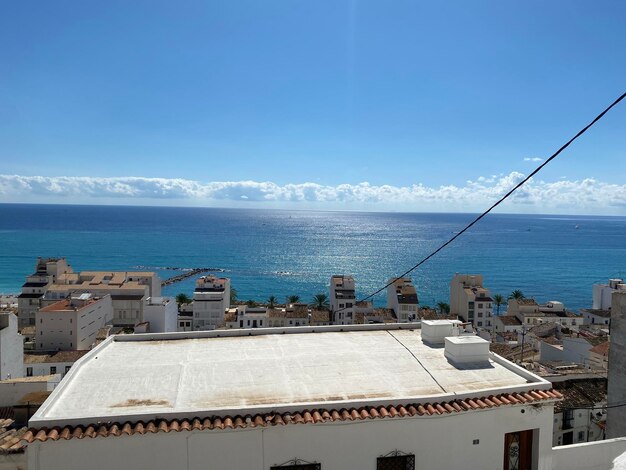 High angle view of buildings by sea against sky