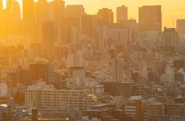 High angle view of buildings in city at sunset