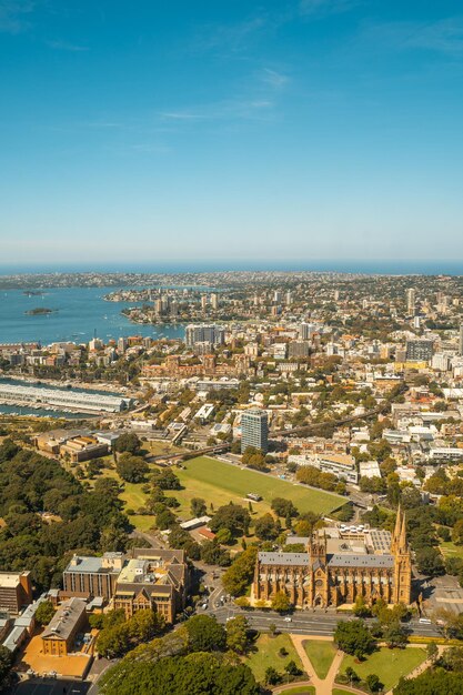 High angle view of buildings and sea against blue sky