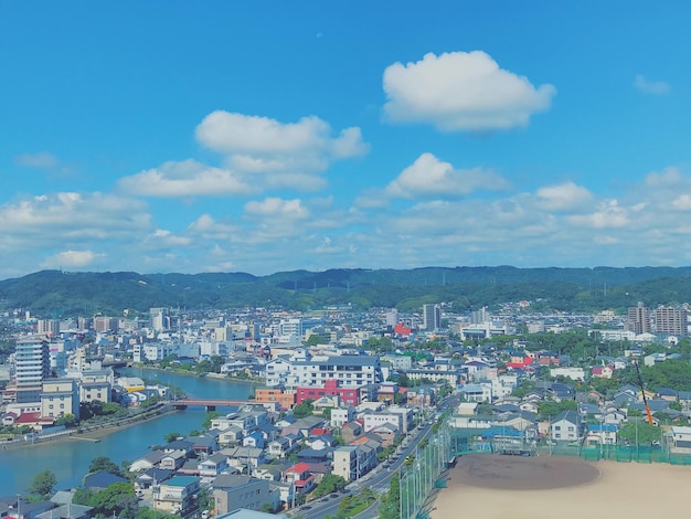 High angle view of buildings and sea against sky