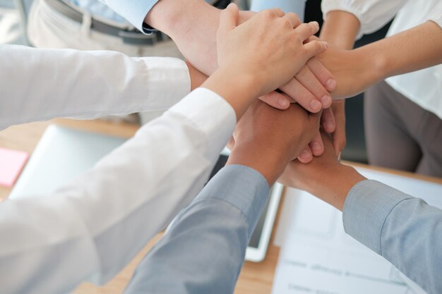High angle view of business people stacking hands
