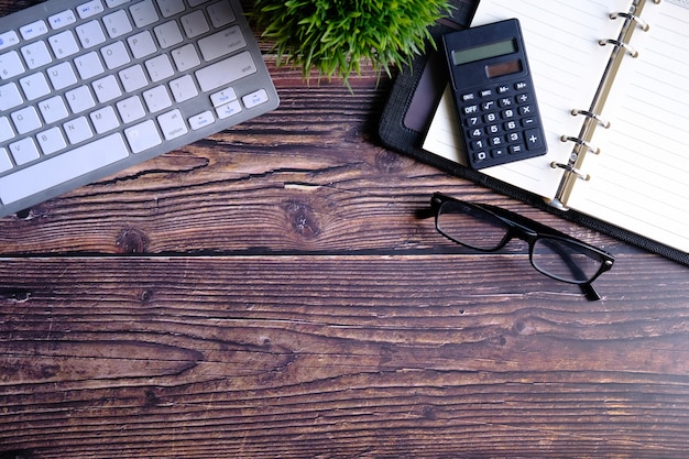 High angle view of calculator, notepad and keyboard with copy space