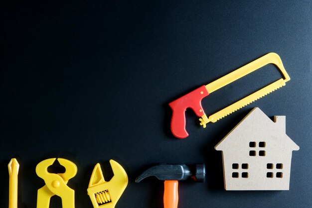 Photo high angle view of carpentry toys with model house over black background