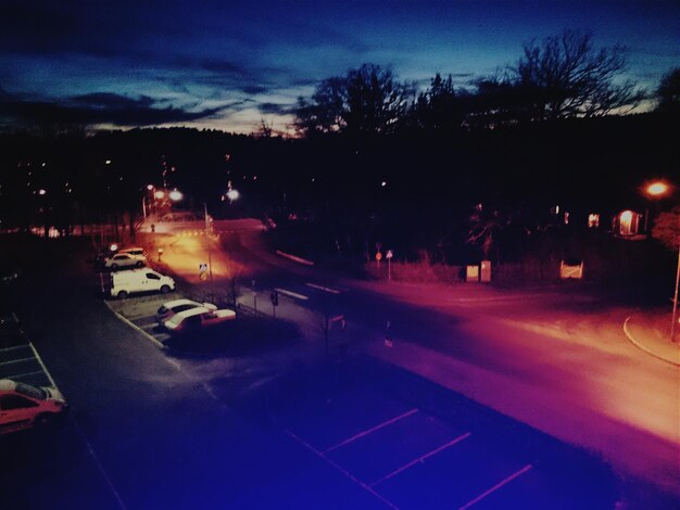 High angle view of cars parked on street at dusk