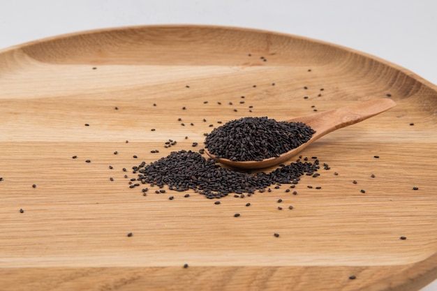 high angle view of chia seeds on wooden spoon and plate