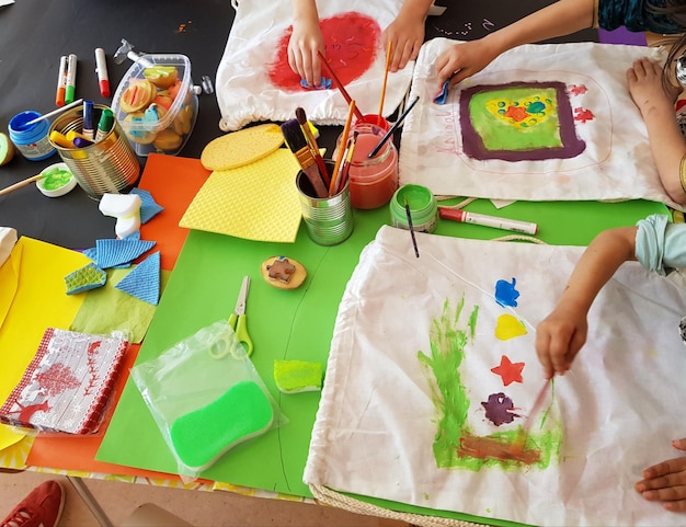 High angle view of children making artwork at table