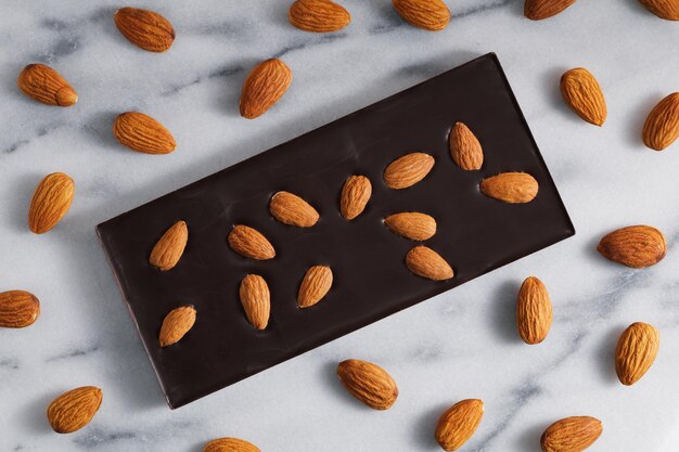 high angle view of chocolate bar and almonds on table