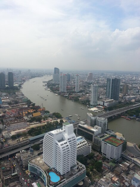 High angle view of city against cloudy sky