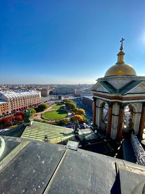 High angle view of city buildings against clear blue sky