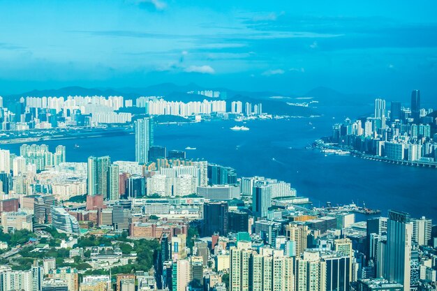 High angle view of city by sea against blue sky