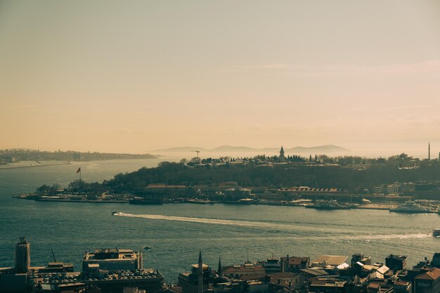 High angle view of city by sea against sky