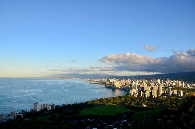 High angle view of city by sea against sky