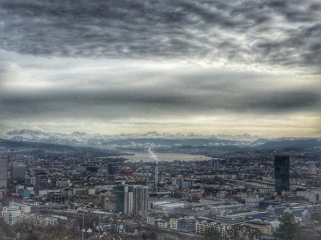 High angle view of cityscape against cloudy sky