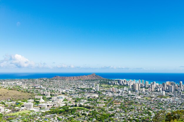 High angle view of cityscape by sea against clear sky