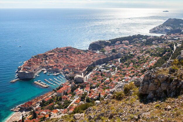 High angle view of cityscape by sea against sky