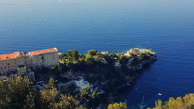 High angle view of cityscape by sea against sky