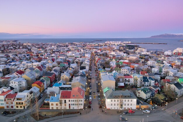 High angle view of cityscape by sea against sky