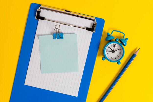 High angle view of clock on yellow background