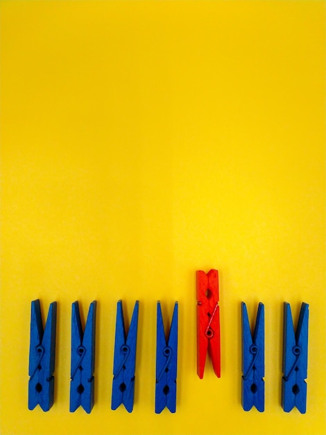 High angle view of clothespins over yellow background