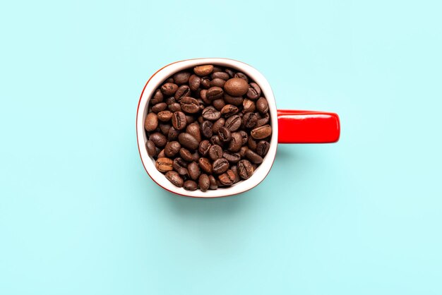 High angle view of coffee beans against blue background