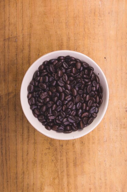 High angle view of coffee beans in bowl on table