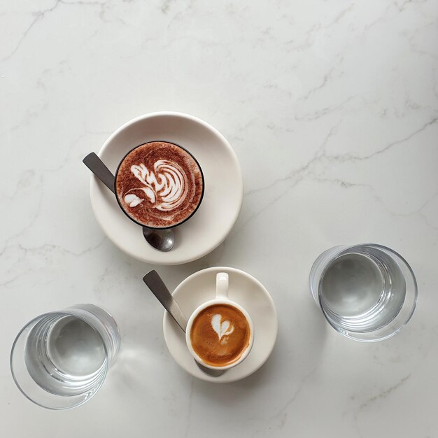 High angle view of coffee on table with water